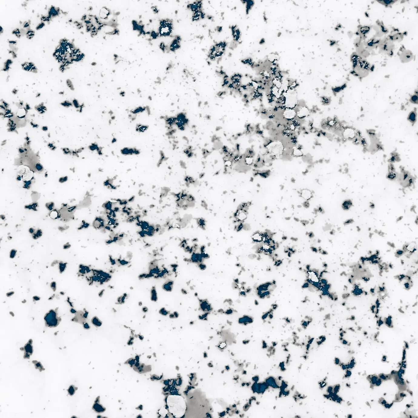 Textured Holi powder in weathered gray on a white background