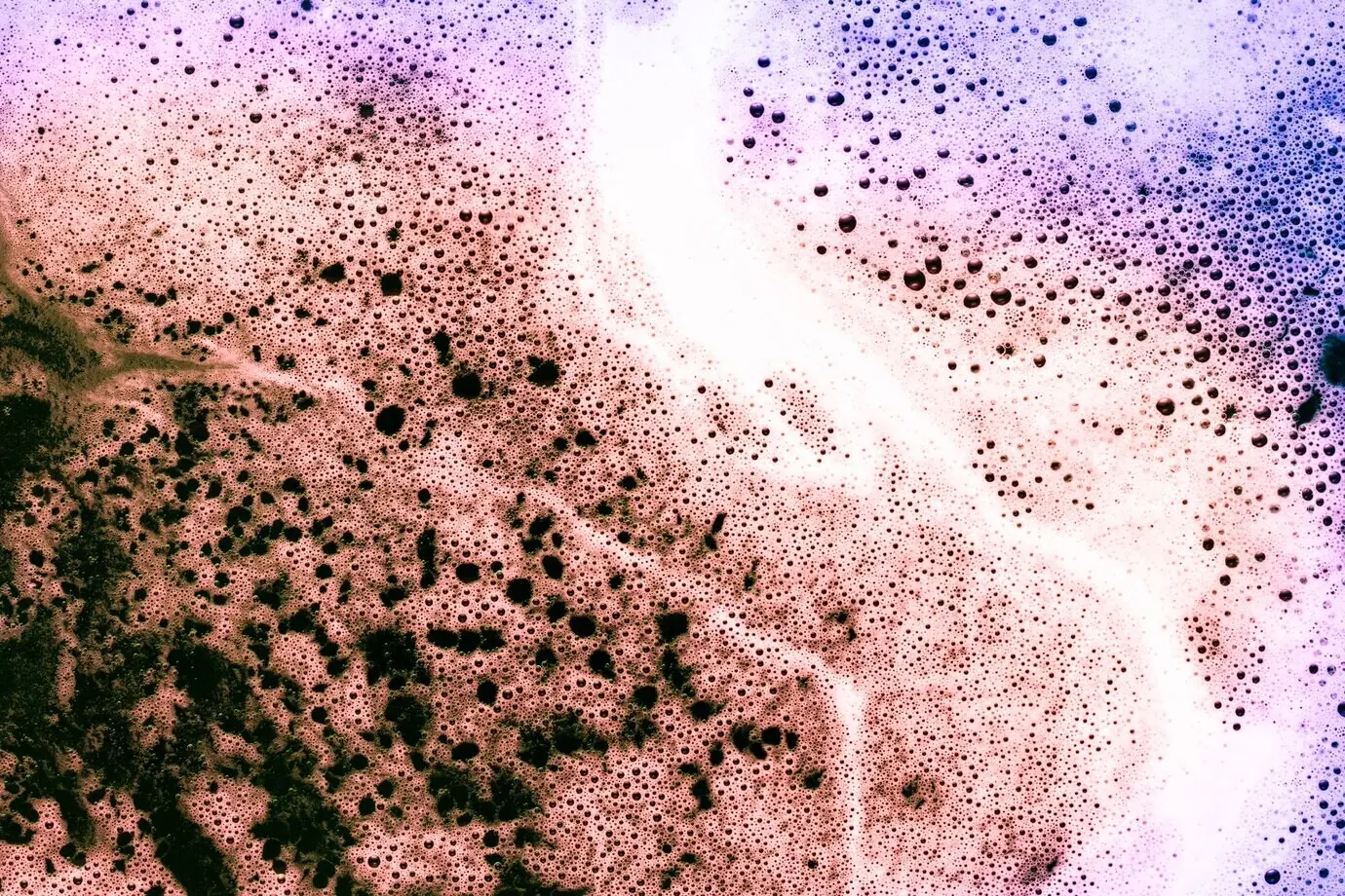 Foam atop a gradient-colored liquid